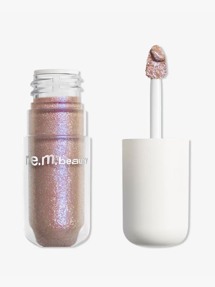 R.E.M. Starlet Lustrous Liquid Eyeshadow vial of duochrome pink liquid eye shadow on light gray background