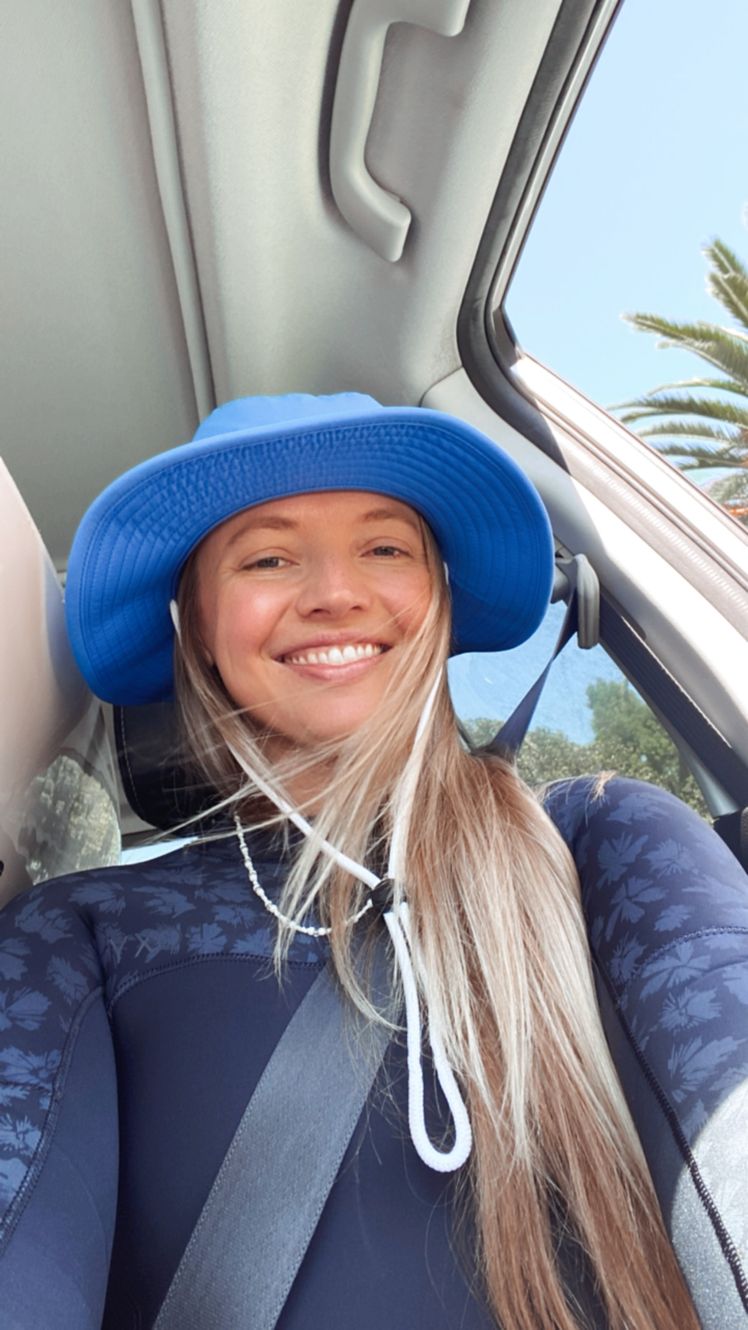 Image may contain Face Head Person Photography Portrait Clothing Hat Cap Happy Smile Adult and Baseball Cap