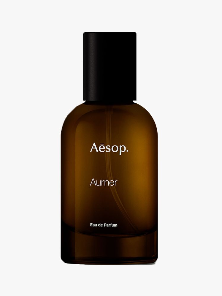 bottle of aesop aurner perfume on a light gray background