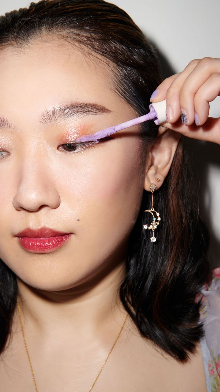 sarah han applying shimmery lilac eyeshadow to eyelids