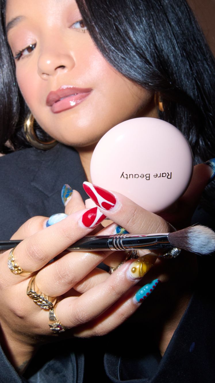 Image may contain Head Person Face Accessories Jewelry Ring Body Part Hand Adult Finger Egg Food and Brush