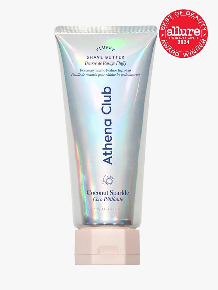Athena Club Fluffy Shave Butter branded tube component with blue accents and pink cap on a light gray background with...