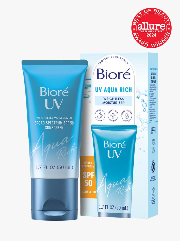 sunscreen in branded blue tube next to branded box packaging on light gray background with red and white 2024 allure...