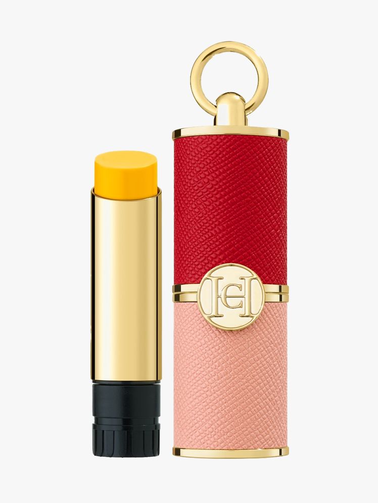 Carolina Herrera Good Girl Mini Tint Set gold tube of yellow lip balm and pink and red leather refillable case on light...