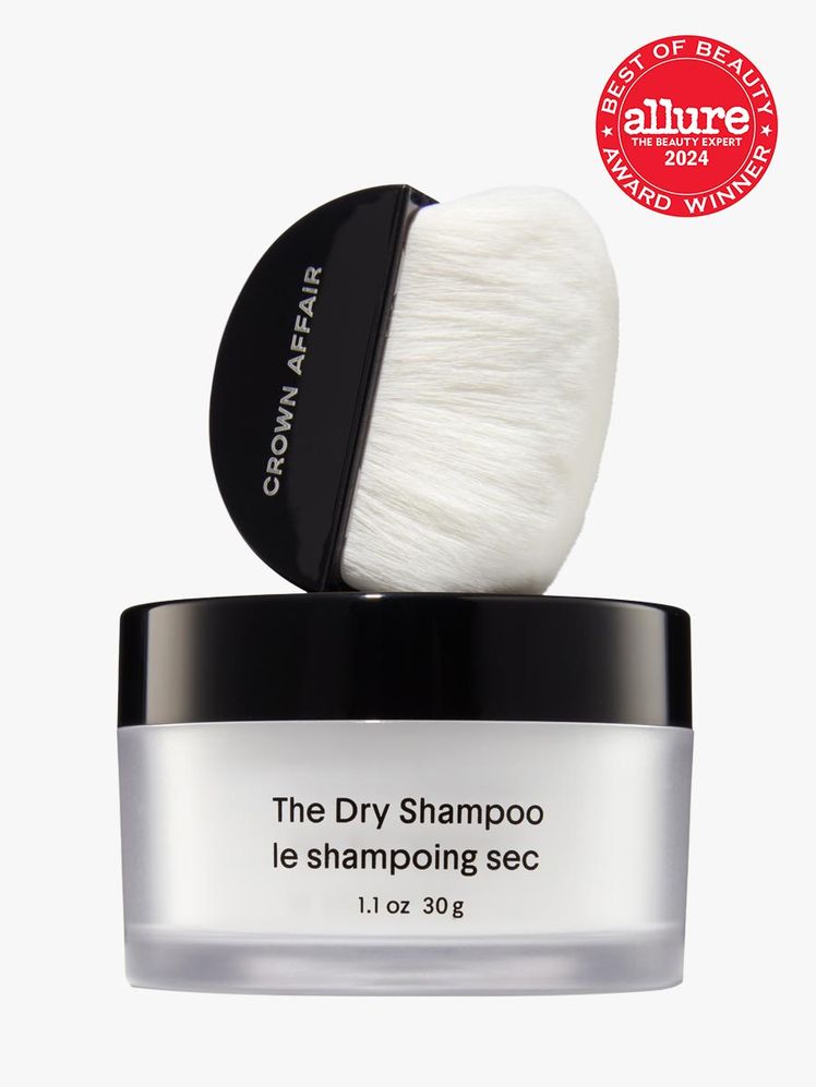 dry shampoo in branded clear tub with black lid with matching branded brush applicator in black and white on light gray...