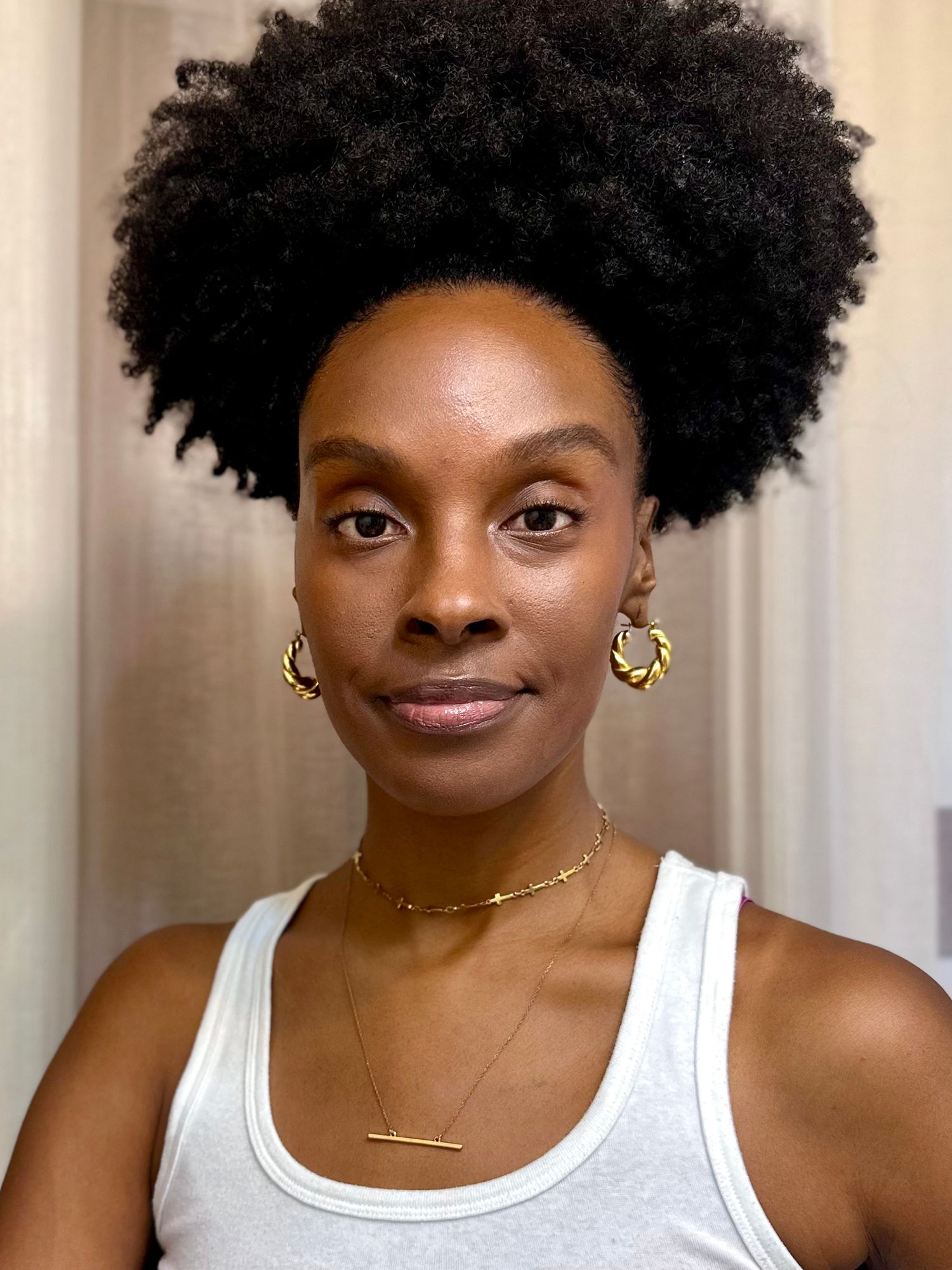 a woman with dark skin after covering up her dark circles