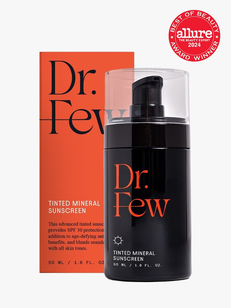sunscreen in branded black bottle with pump next to branded orange box packaging on light gray background with red and white 2024 allure best of beauty seal
