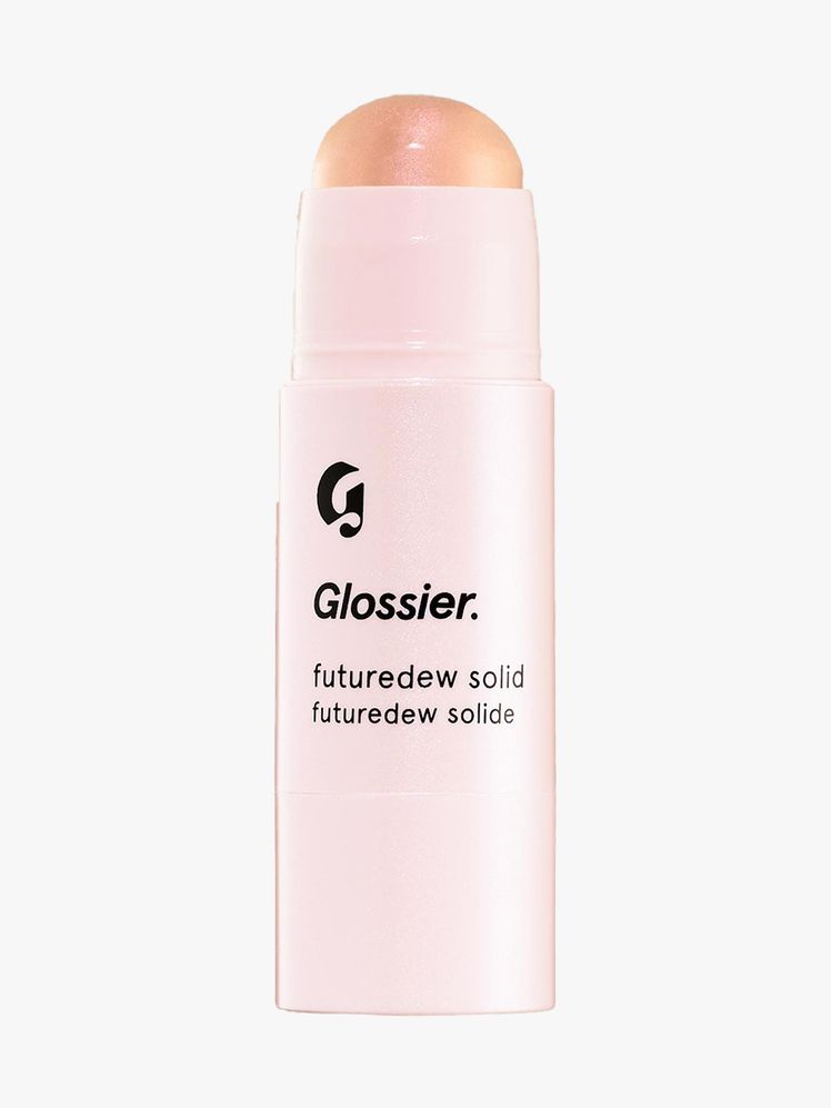 Glossier Futuredew Solid light pink twist up highlighter balm stick on light way background