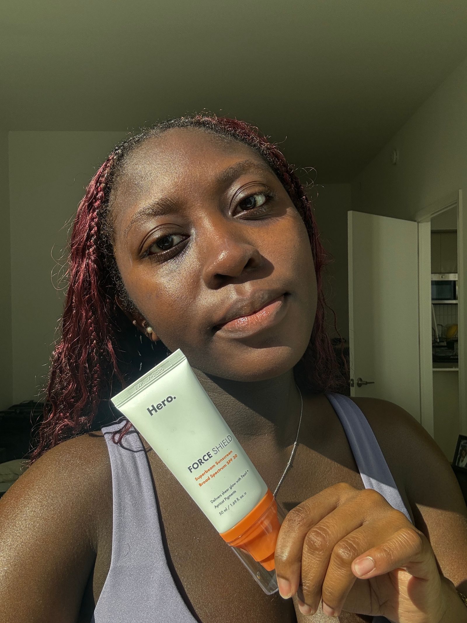 A selfie of Allure associate beauty editor Annie Blay after applying Hero Cosmetics Mineral Sunscreen on dark skin