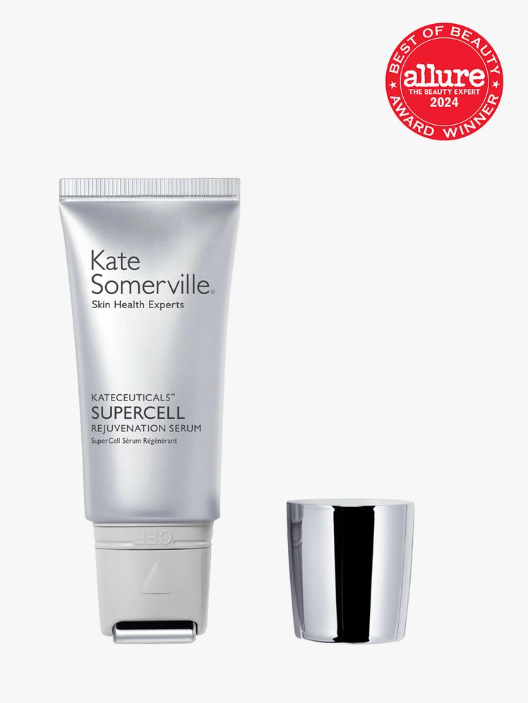 facial serum in branded silver bottle with applicator tip next to silver cap on light gray background with red and white...