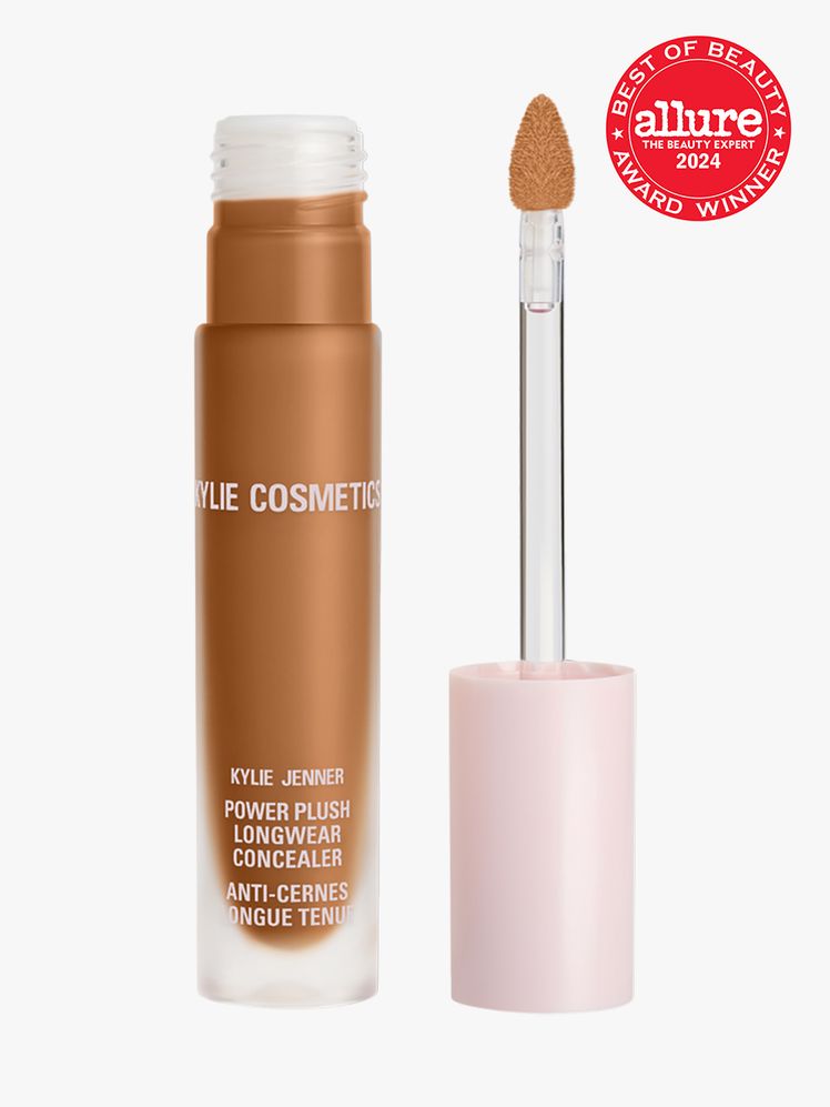 Kylie Cosmetics Power Plush Longwear Concealer branded twist up component with pink cap and white accents on a light...
