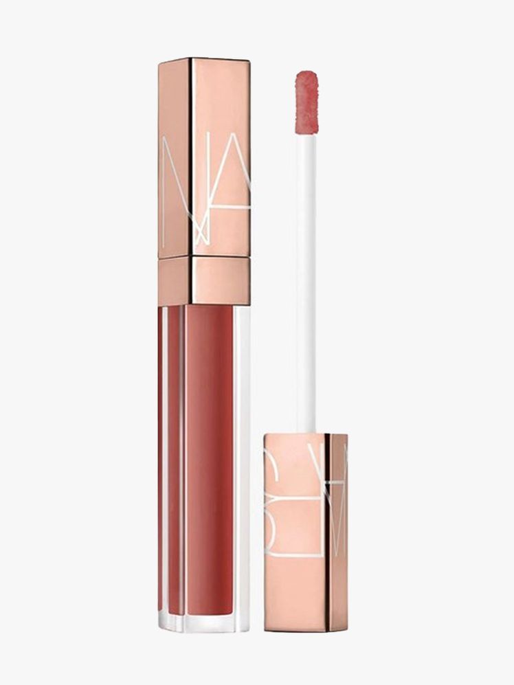 Nars Afterglow Lip Shine Lip Gloss vial of reddish lip gloss with rose gold cap on light gray background