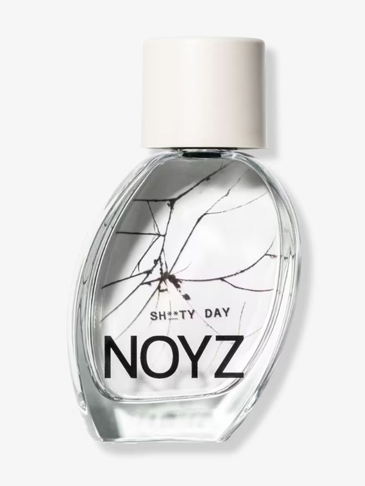 Noyz Shty Day Eau de Parfum tilted oval bottle of perfume with white cap on light gray background