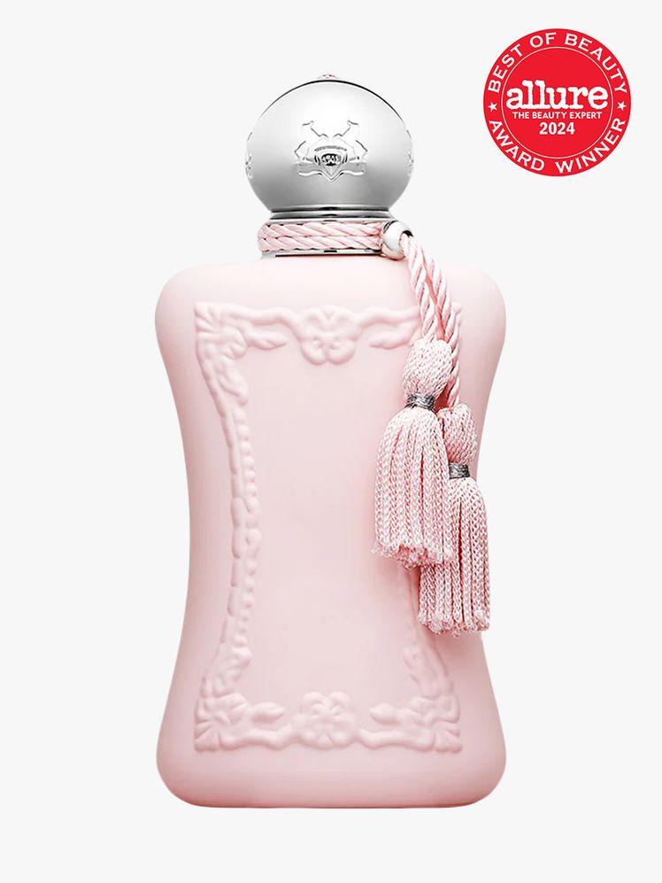 Parfums de Marly Delina bottle component in pink with silver accents and tassles on a light gray background with red...