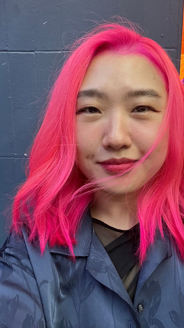 Image may contain Hair Person Adult Pink Hair Clothing and Coat