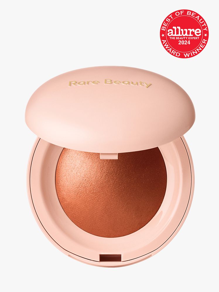 Rare Beauty Positive Light Silky Touch Highlighter branded component in pink with gold accents on a light gray...