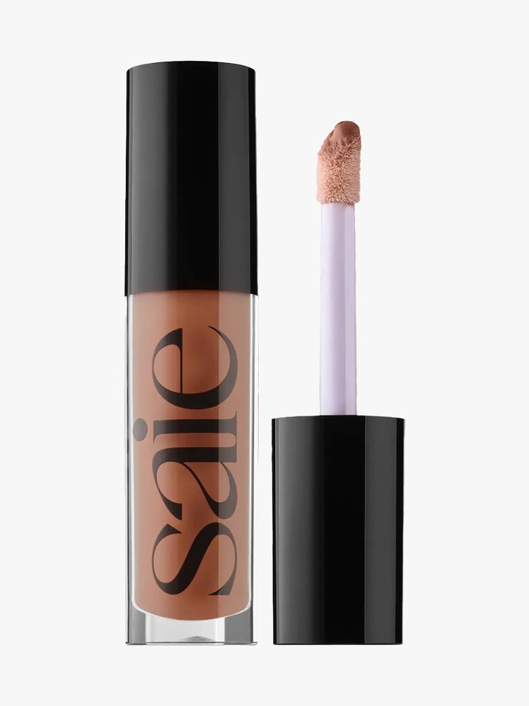Saie Glossybounce HighShine Hydrating Lip Gloss Oil tube of warm brown lip gloss with black cap on light gray background