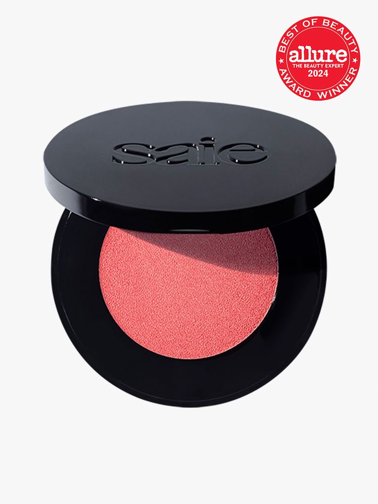 Saie Glow Sculpt MultiUse Cream Highlighting Blush in branded black component on a light gray background with red Allure...