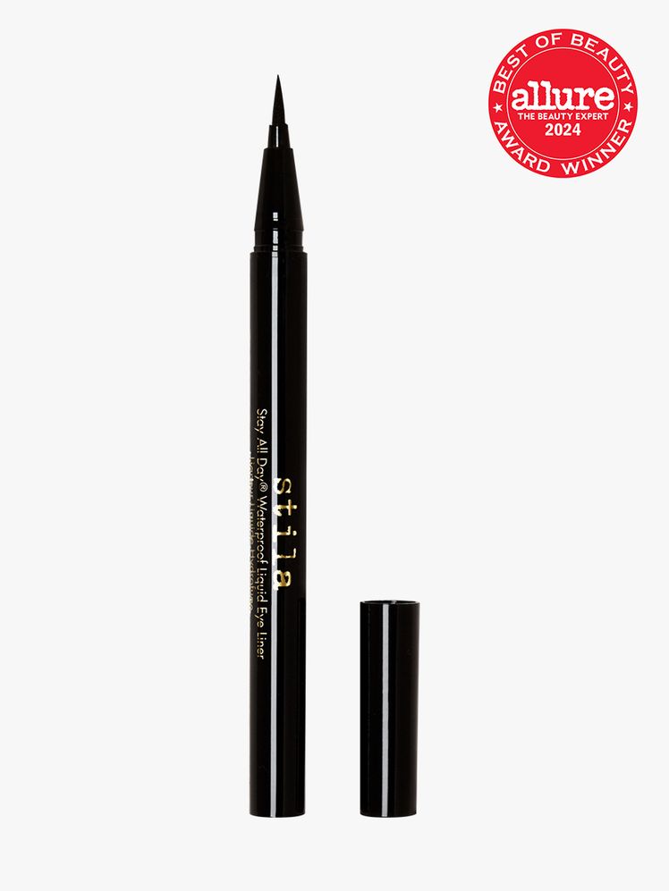 Stila Stay All Day Waterproof Liquid Eye Liner in black with gold accents on a light gray background with red Allure...