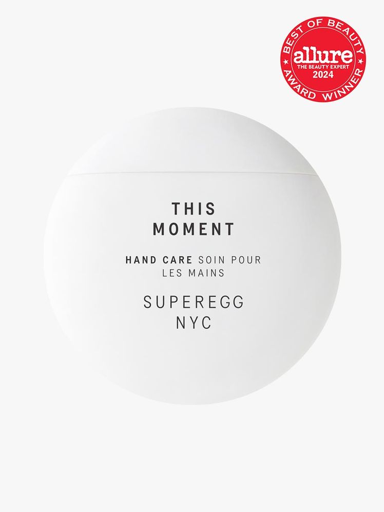 Superegg This Moment Hand Care branded white component with black accents on a light gray background with red Allure...