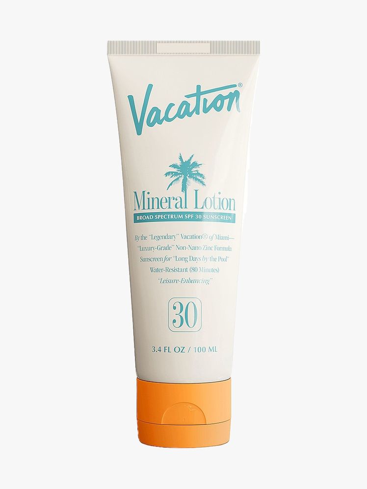 Vacation Mineral Lotion SPF 50 beige tube with orange cap on light gray background
