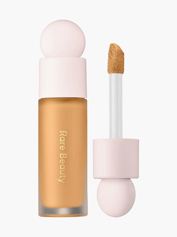 Rare Beauty Concealer in 260 N in branded clear tube packaging with soft pink doe foot applicator on light gray background
