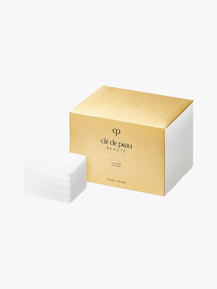 Cl de Peau Beaut Cotton in branded gold component on a light gray background