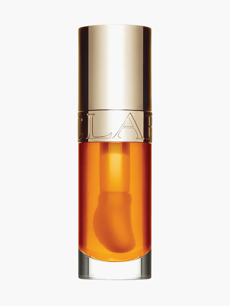 Clarins Lip Comfort Oil Hydrating and Plumping Lip Oil in Honey in branded clear tube with gold cap on light gray background