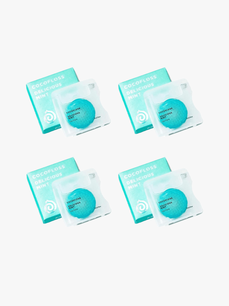 Cocofloss Dental Floss in branded blue component with black and white accents on a light gray background