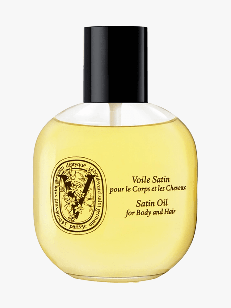Diptyque Satin Oil in branded bottle component with black cap on a light gray background