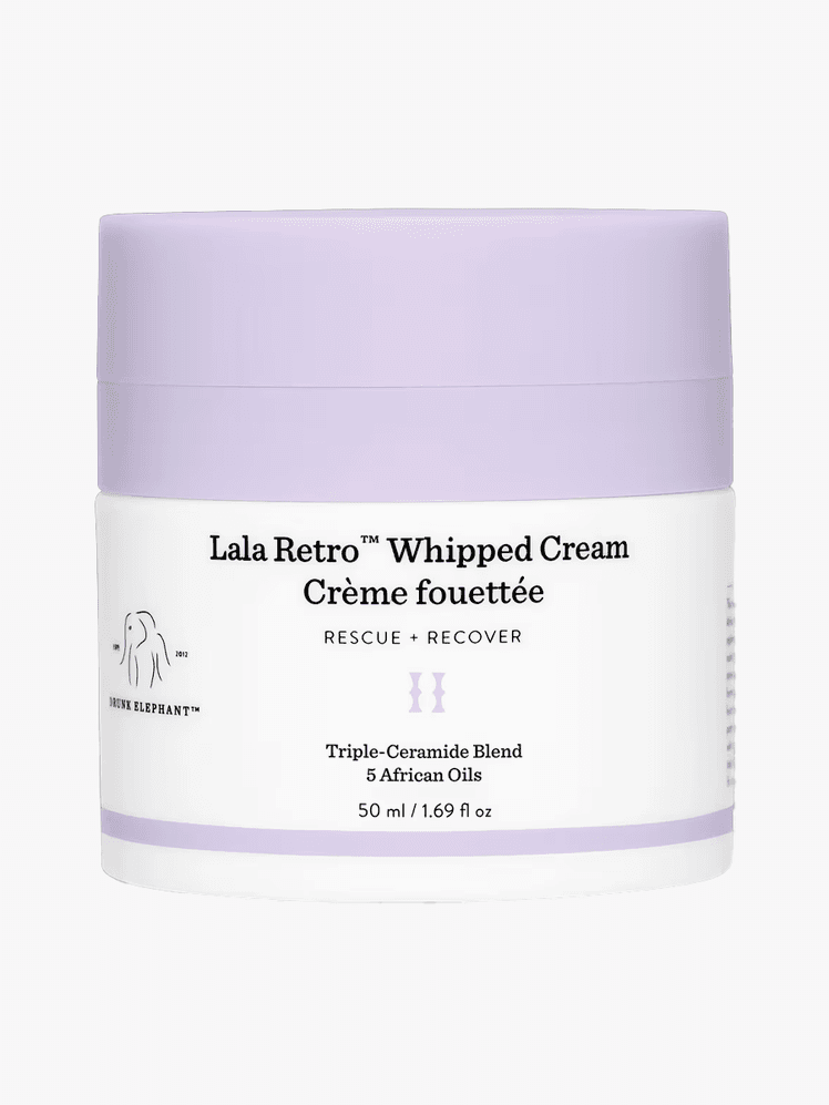 Drunk Elephant LaLa Retro Whipped Cream in white tub component with purple accents on a light gray background