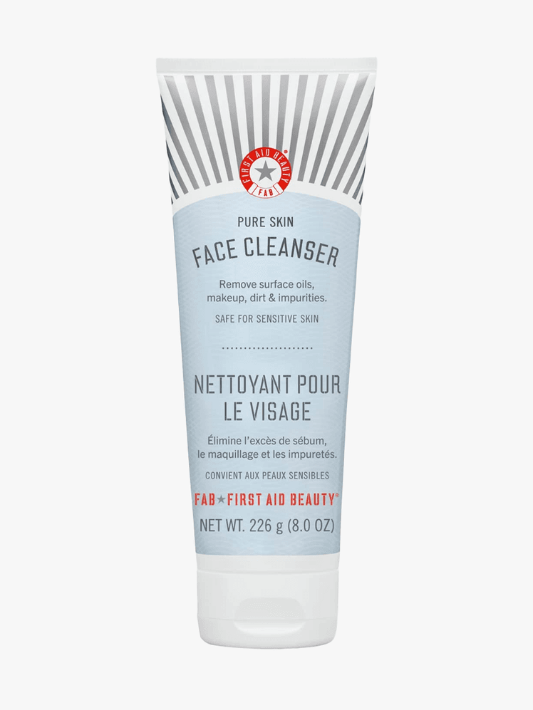 First Aid Beauty Cream Face Cleanser in blue branded tube component with white cap on a light gray background