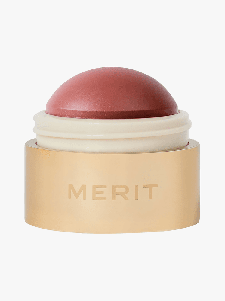 Merit Flush Balm in gold and beige component on light gray background