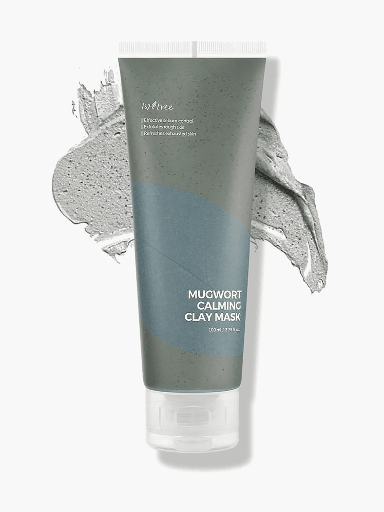 Mugwort Calming Clay Mask in branded dark sage green tube with white cap on top of product swatch on light gray background