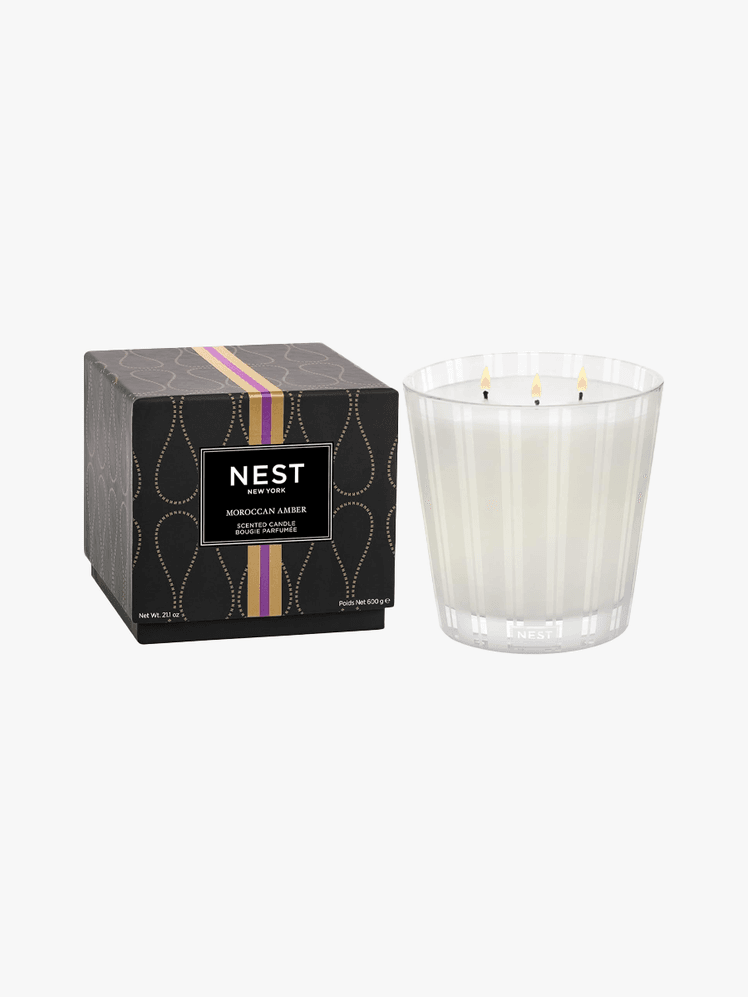 NEST Moroccan Amber 3Wick Candle in branded component on a light gray background