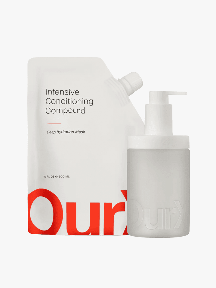 Pouch of OurX's intensive conditioning compound with an empty bottle next to it on a grey background