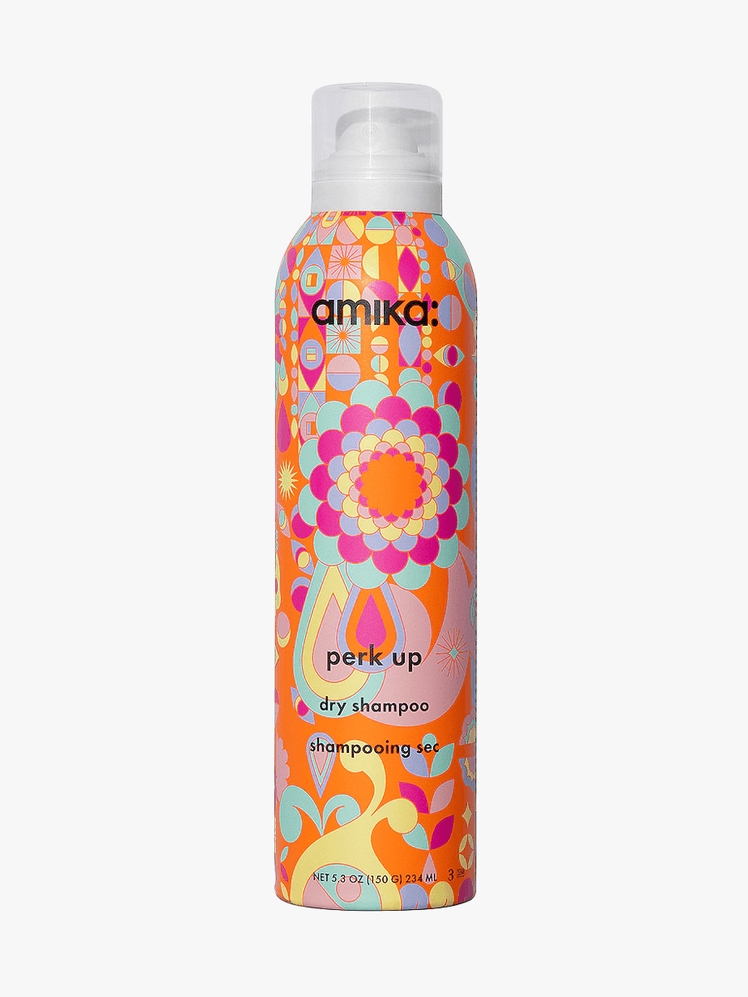 Perk Up Dry Shampoo in colorful branded component with clear cap on a light gray background