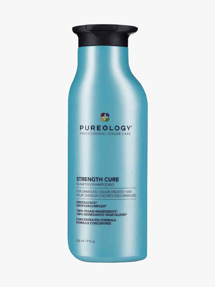 Pureology Strength Cure Shampoo in branded blue bottle component with black cap on a light gray background