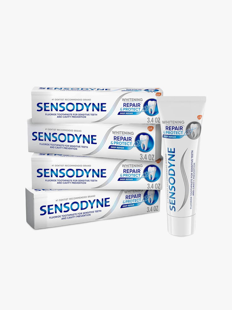 Repair and Protect Whitening Toothpaste in branded white and teal tube next to branded box packaging in four pack